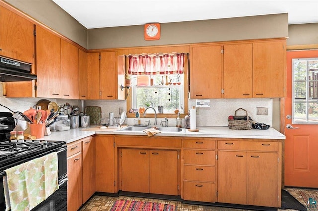 kitchen with range with gas stovetop, backsplash, sink, and range hood