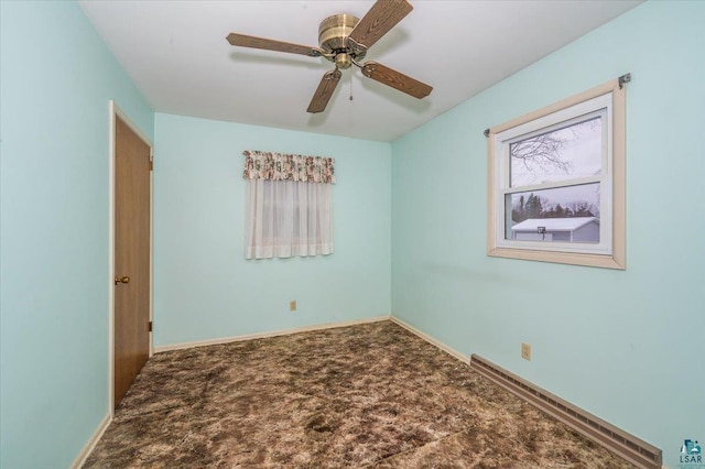 empty room featuring carpet and ceiling fan