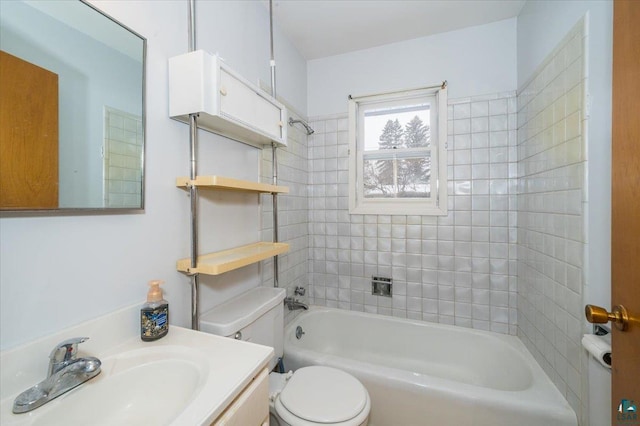 full bathroom featuring vanity, tiled shower / bath combo, and toilet