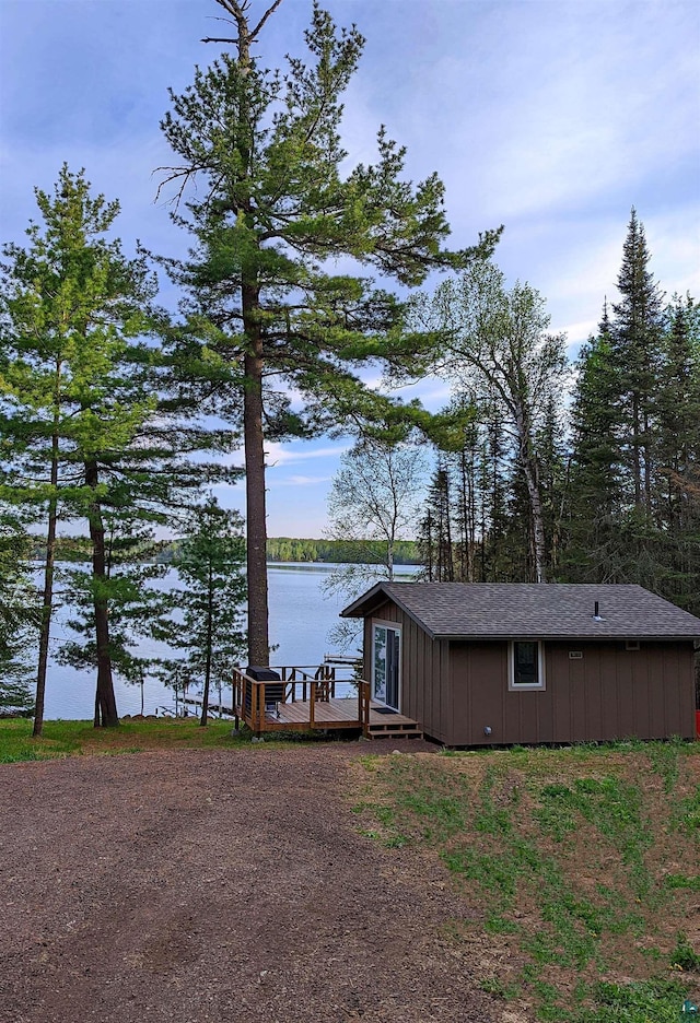 back of property with a water view