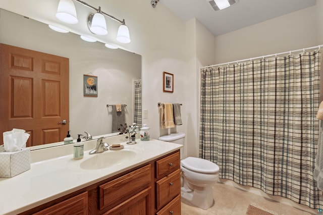 bathroom with tile patterned flooring, vanity, and toilet