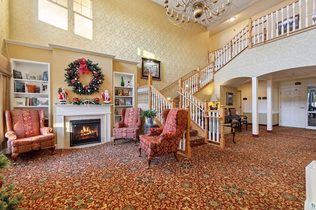 living room featuring built in features, a towering ceiling, and an inviting chandelier