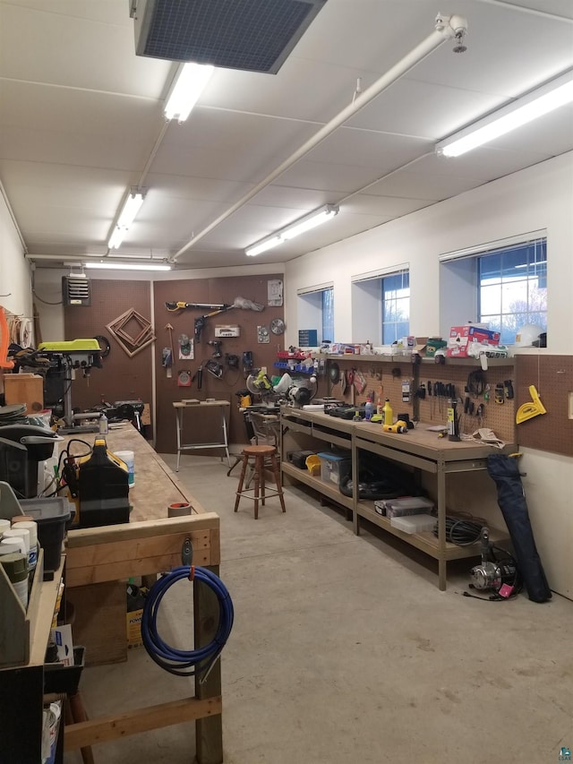 miscellaneous room featuring a workshop area and concrete floors