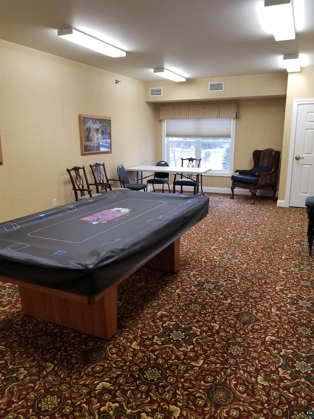 game room with dark colored carpet