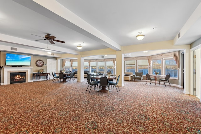 unfurnished dining area with ceiling fan and beamed ceiling