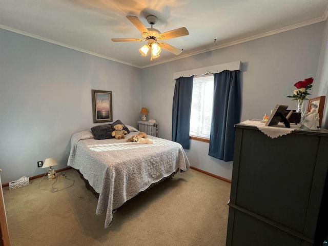 carpeted bedroom featuring ceiling fan and crown molding