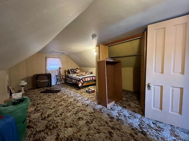 carpeted bedroom featuring lofted ceiling