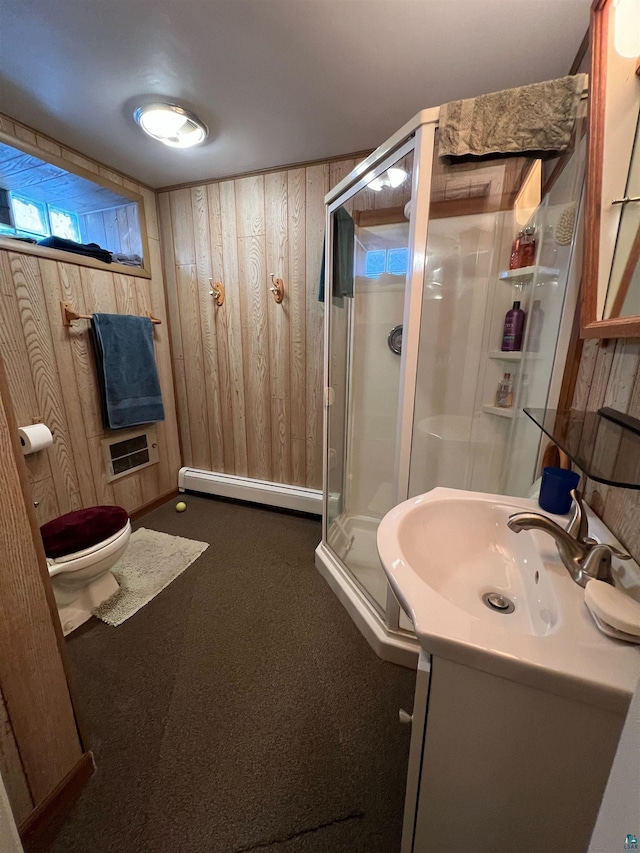 bathroom featuring vanity, a baseboard radiator, a shower with door, and wooden walls