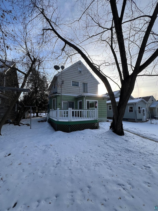 view of snow covered rear of property