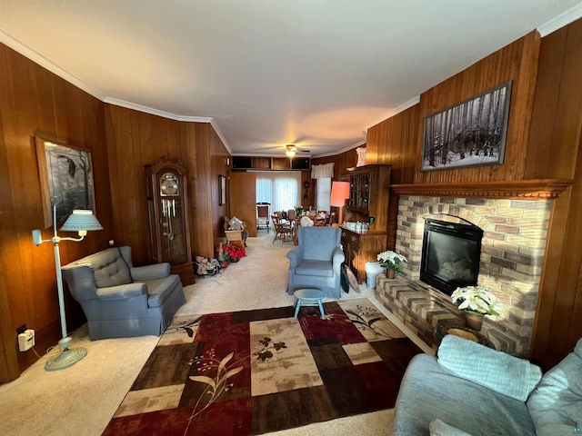 living room with carpet flooring, ceiling fan, crown molding, and a brick fireplace