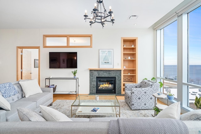 living room featuring light hardwood / wood-style floors and an inviting chandelier