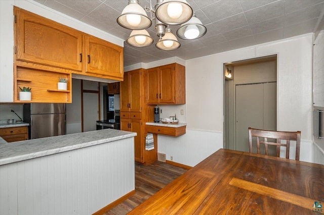 kitchen with butcher block countertops, dark wood-type flooring, appliances with stainless steel finishes, and a chandelier