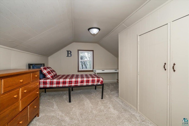 carpeted bedroom featuring lofted ceiling