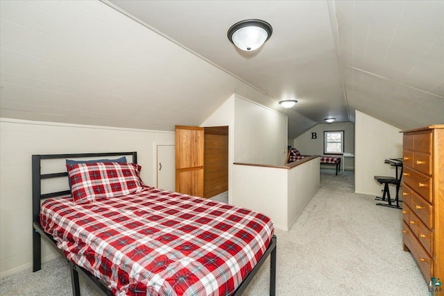 carpeted bedroom with lofted ceiling