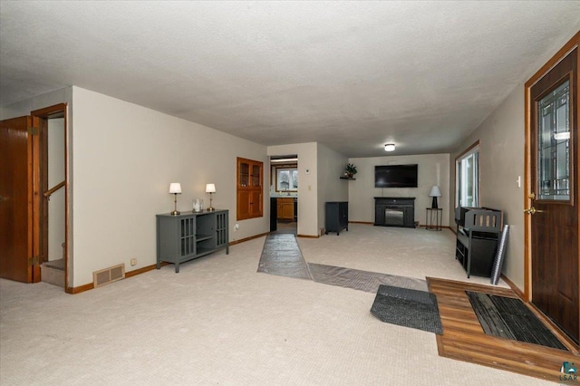 living room with carpet floors and a textured ceiling