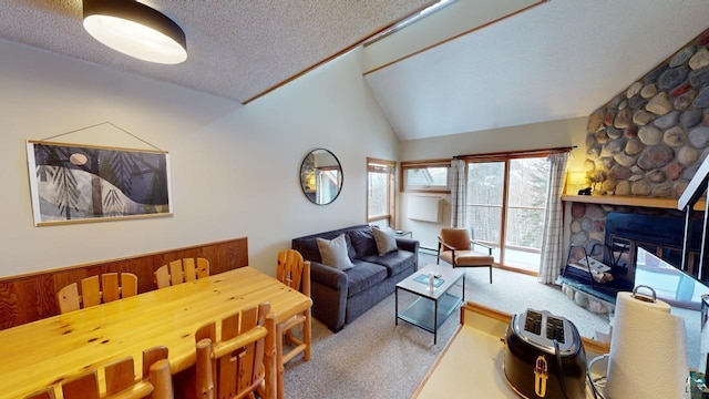 carpeted living room with a textured ceiling, lofted ceiling, and a fireplace