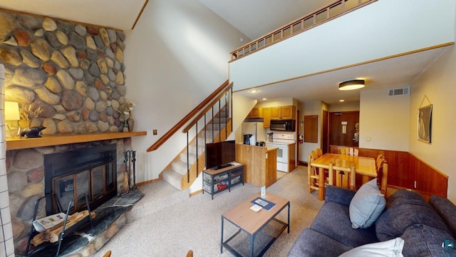 living room with a fireplace and light carpet