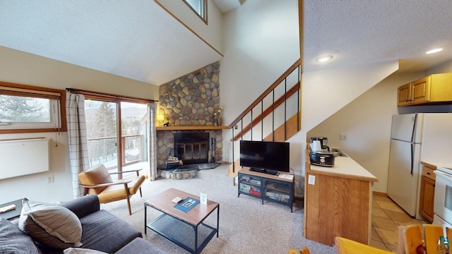 carpeted living room featuring a textured ceiling, a stone fireplace, and vaulted ceiling