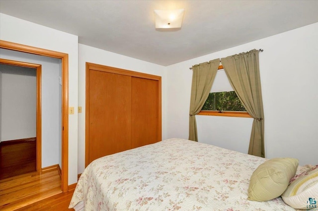 bedroom featuring hardwood / wood-style flooring and a closet