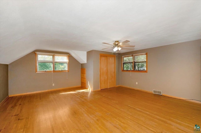 bonus room featuring light wood-type flooring, ceiling fan, and lofted ceiling