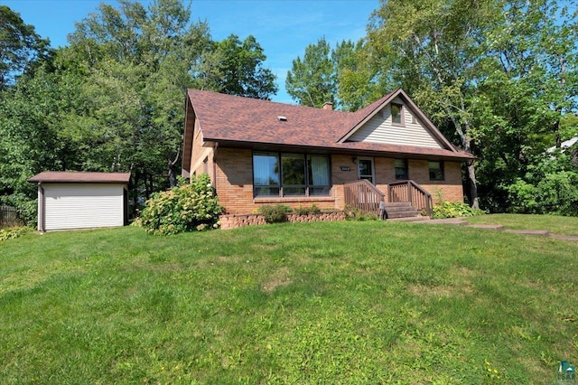 view of front facade featuring a front lawn and a storage shed