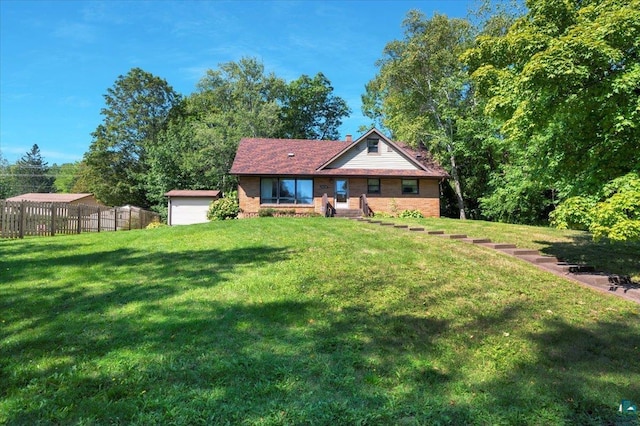 exterior space featuring a lawn, a garage, and an outdoor structure