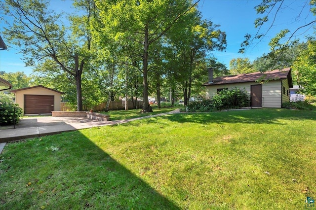 view of yard featuring an outbuilding and a garage