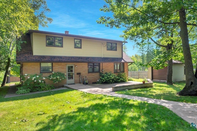 view of front facade featuring a patio and a front lawn