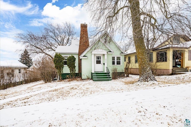 view of snow covered rear of property