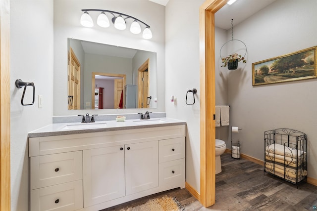 bathroom featuring hardwood / wood-style floors, vanity, and toilet