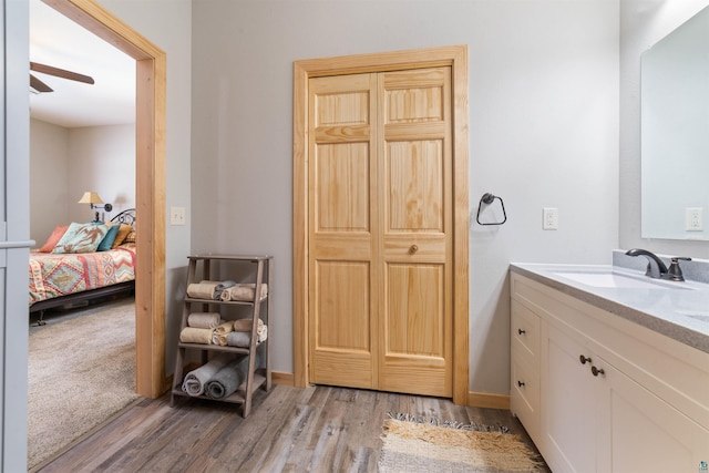 bathroom featuring hardwood / wood-style floors, vanity, and ceiling fan