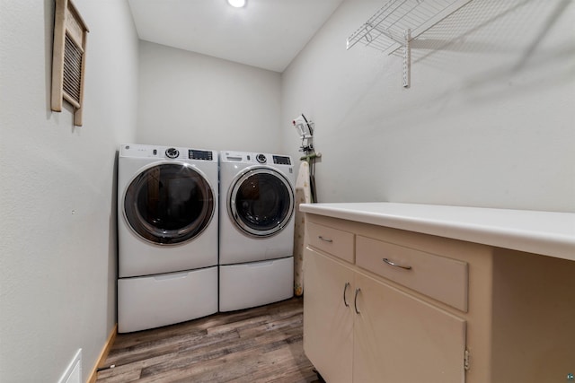 washroom featuring washer and clothes dryer and dark wood-type flooring