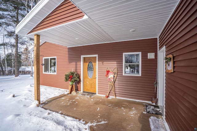 view of snow covered property entrance