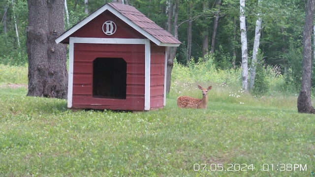 view of outbuilding with a lawn