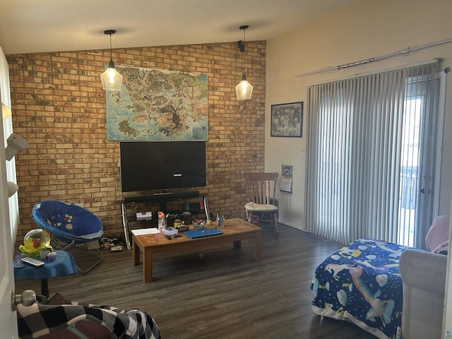 living room featuring a textured ceiling, vaulted ceiling, brick wall, and hardwood / wood-style flooring