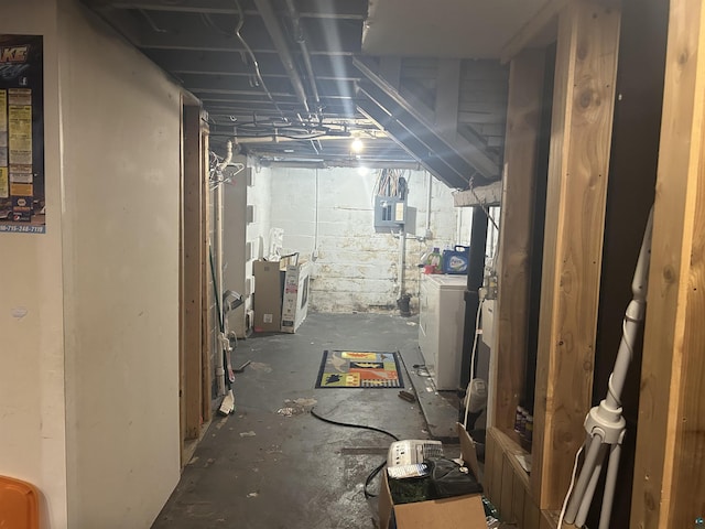 basement with electric panel and washer / clothes dryer