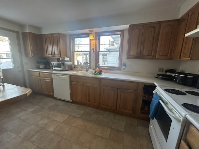 kitchen with sink and white appliances