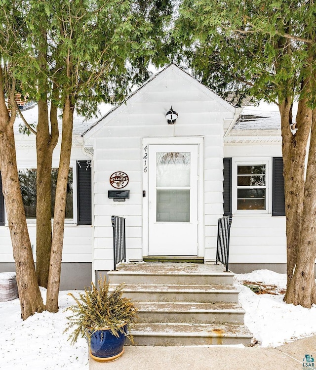 view of snow covered property entrance