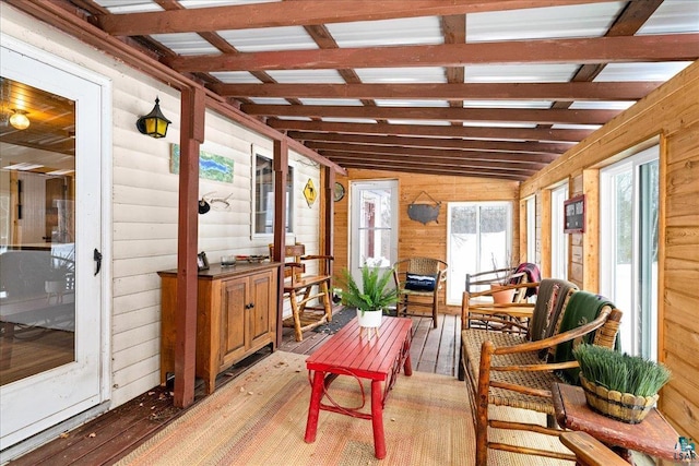 sunroom / solarium featuring lofted ceiling