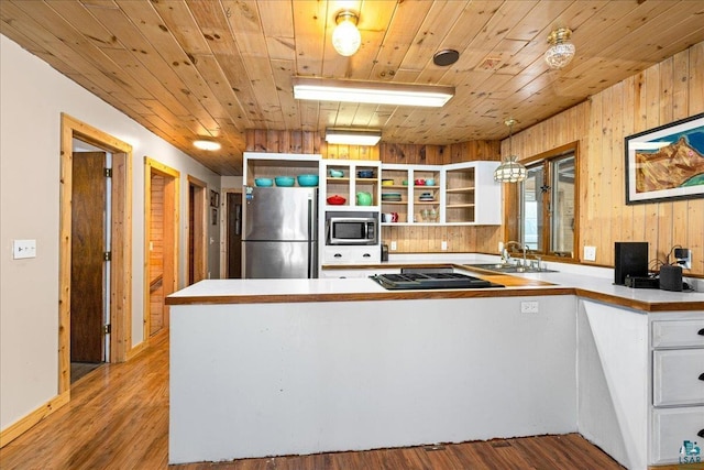 kitchen featuring decorative light fixtures, wood ceiling, white cabinetry, appliances with stainless steel finishes, and sink