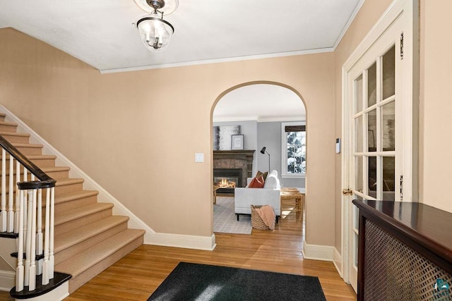 entrance foyer with light hardwood / wood-style flooring and crown molding