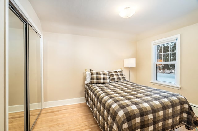 bedroom with a closet and light hardwood / wood-style floors