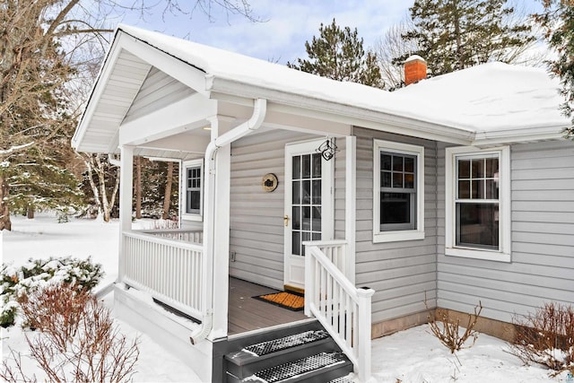 view of snow covered property entrance