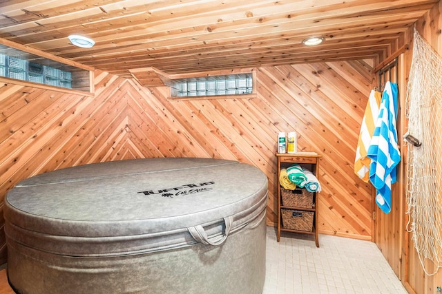 rec room with wood ceiling and wood walls