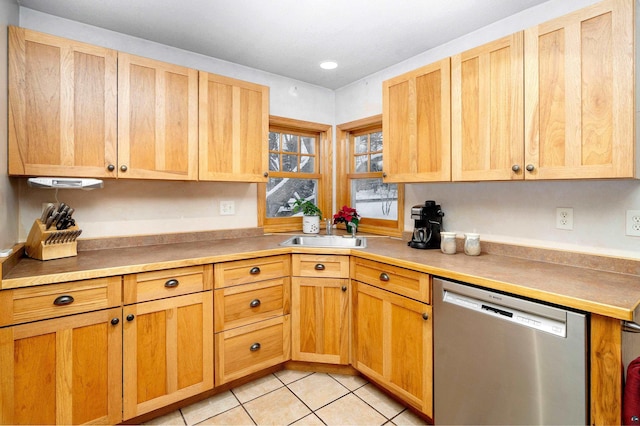 kitchen with dishwasher, sink, and light tile patterned flooring