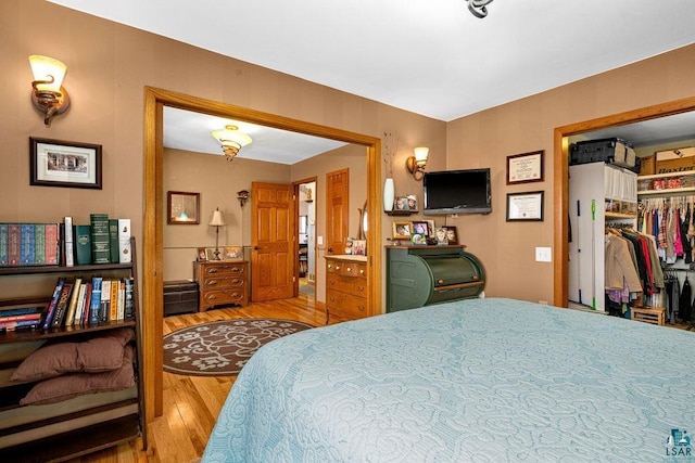 bedroom featuring hardwood / wood-style floors and a closet