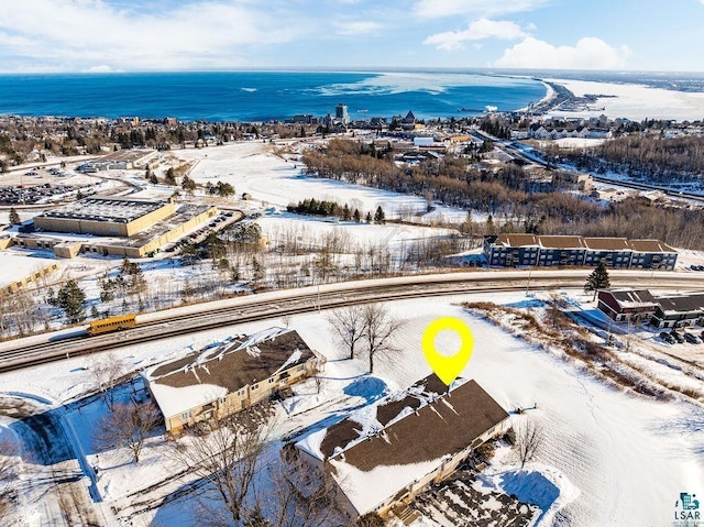 snowy aerial view with a water view