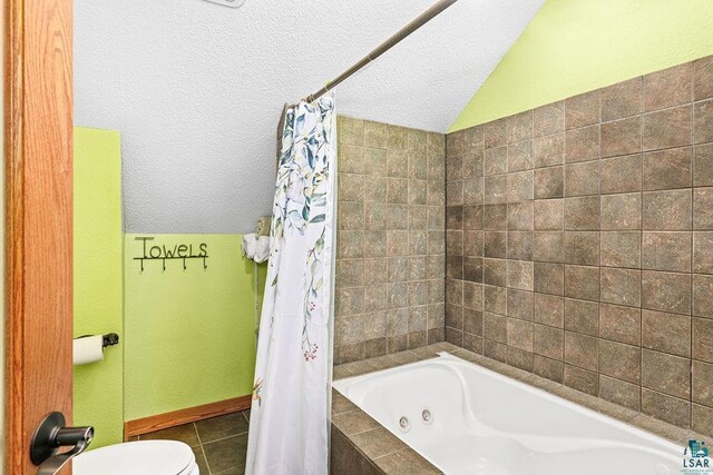 bathroom with toilet, vaulted ceiling, tile patterned floors, shower / bath combination with curtain, and a textured ceiling