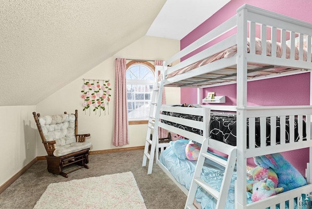 carpeted bedroom with a textured ceiling and vaulted ceiling