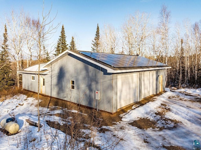 view of snow covered exterior featuring solar panels